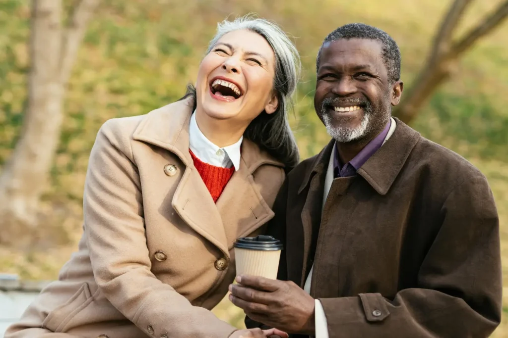 Image of a woman and a man outside in countryside smiling and laughing. Dental fillings in Sutton by Sherwood Park Dental.